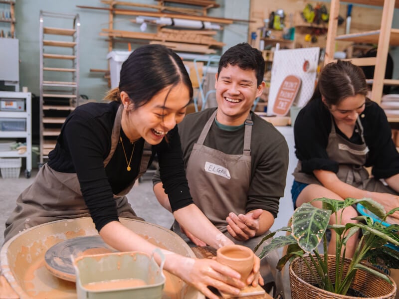 Couple laughing at a pottery workshop in Sydney